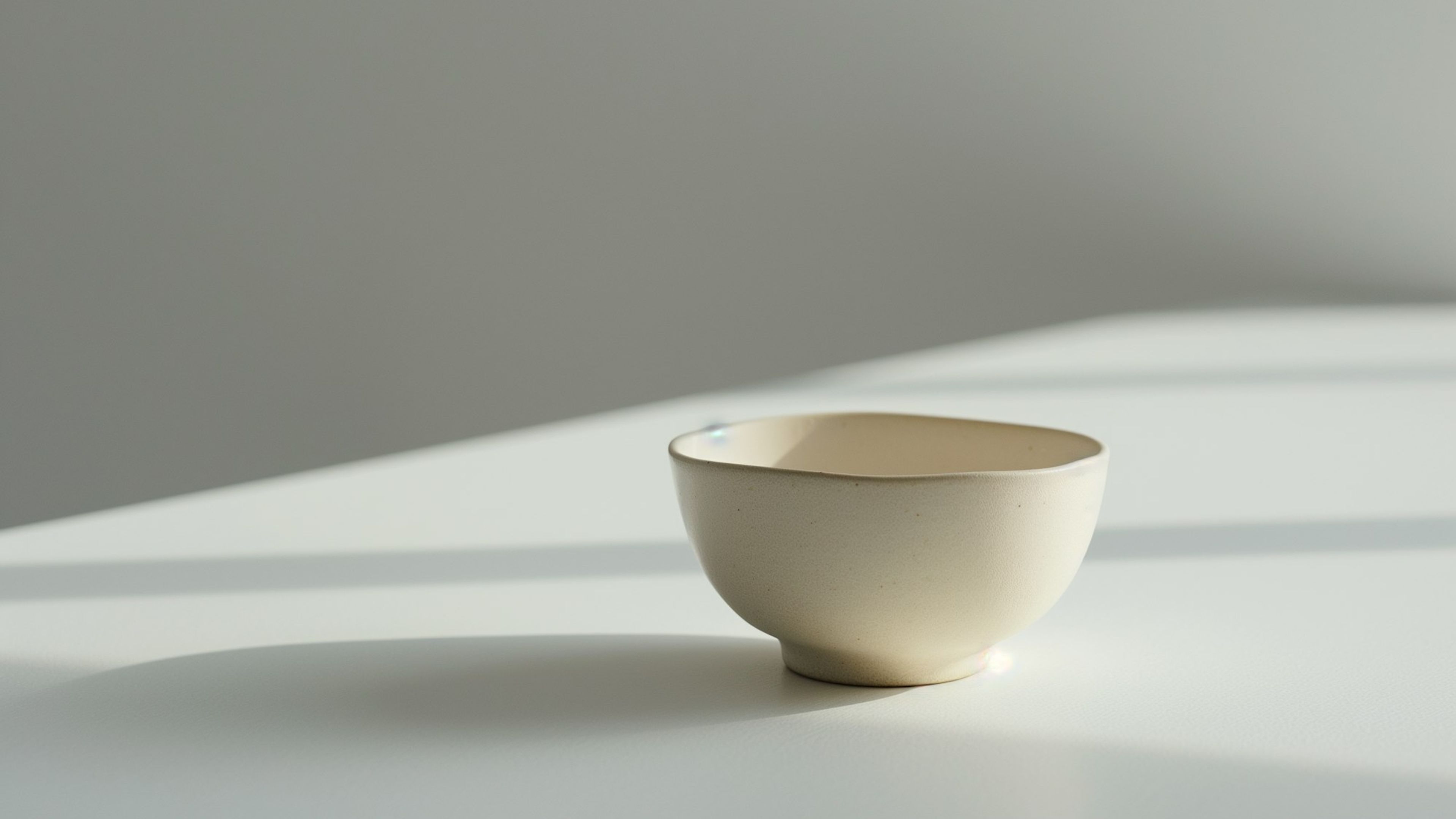 A single ceramic bowl on a pale surface
