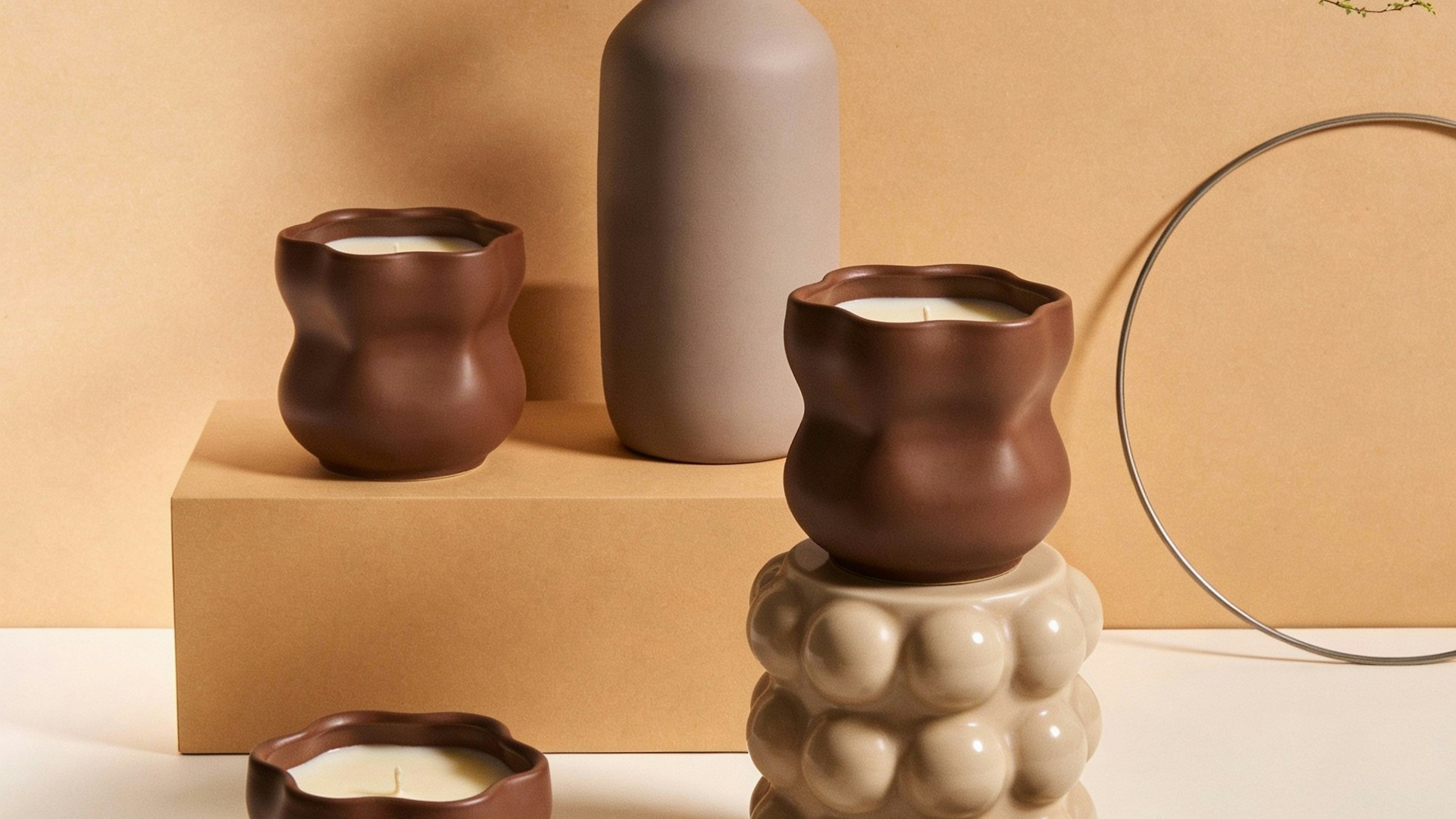 Clay vessels and books arranged on a warm shelf