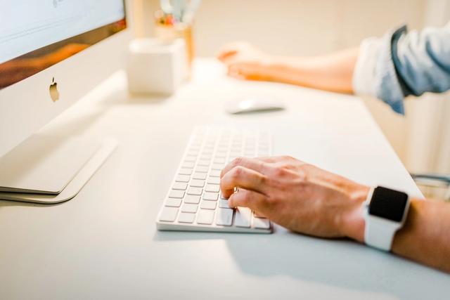 Man in front of Mac keyboard