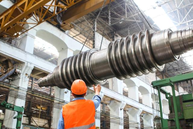 Man with heavy machinery in factory