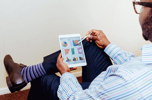 Man with iPad and bright socks