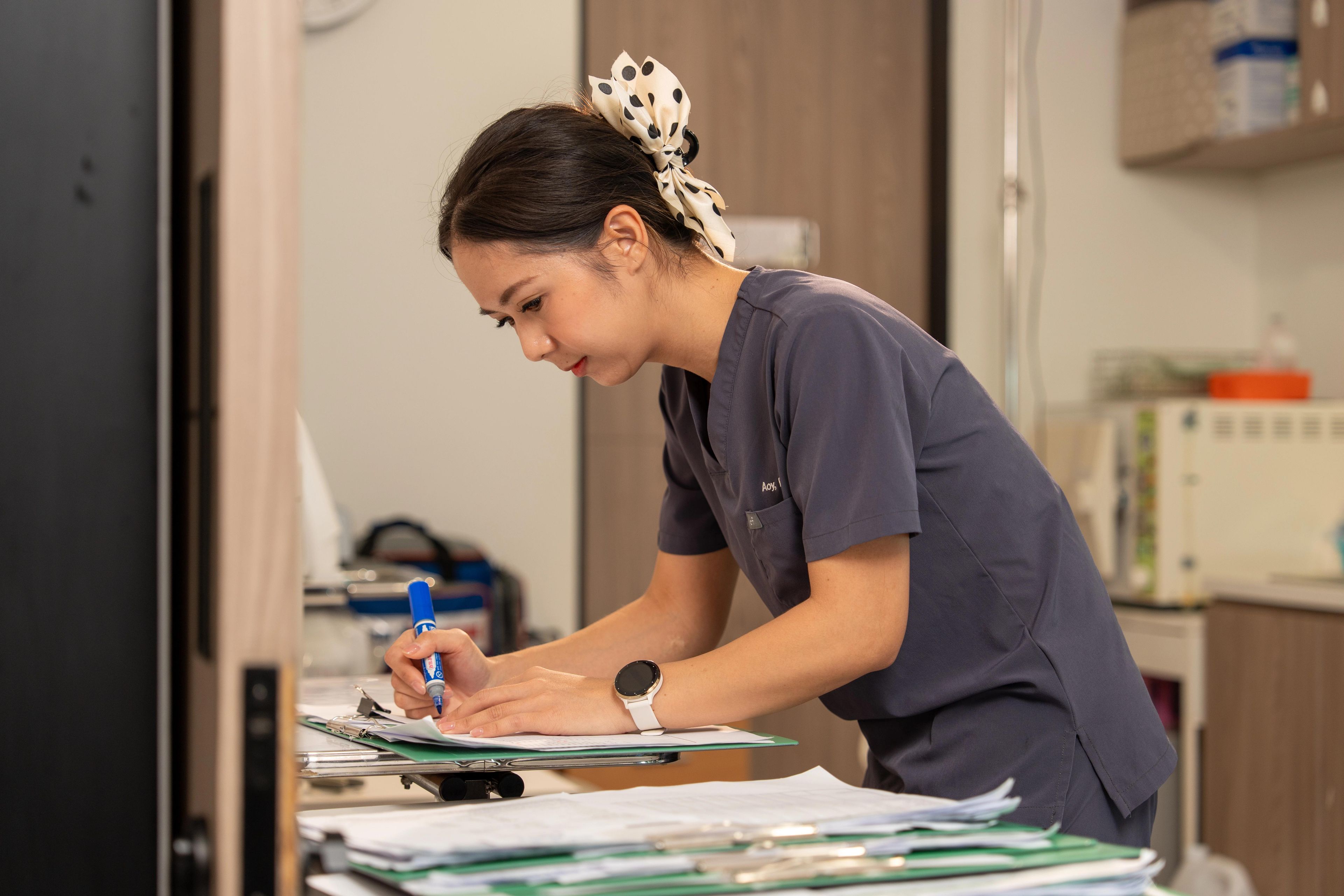 A nurse making notes during care at the clinic