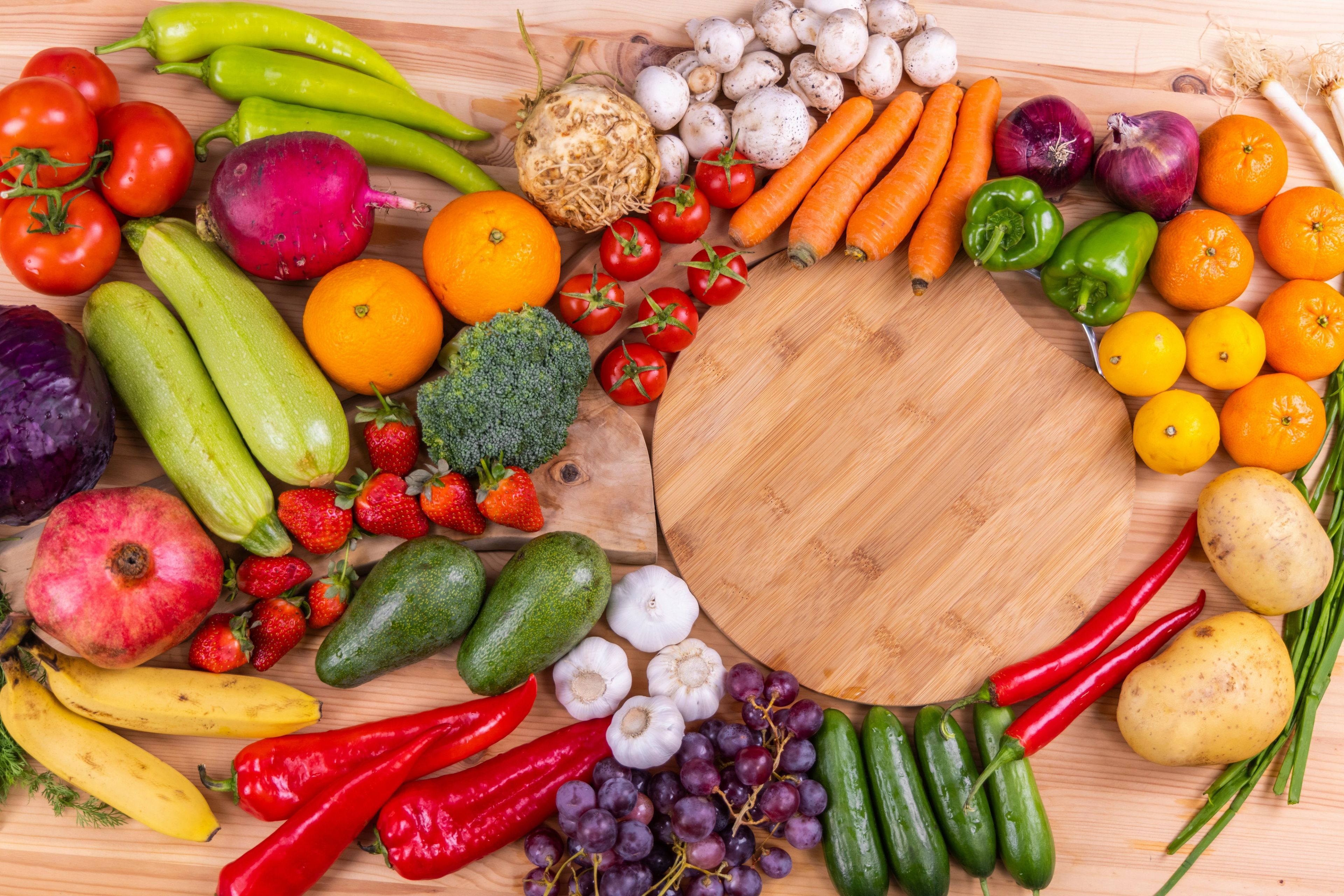 A selection of fresh, colorful vegetables, fruits and other nutrient-rich foods arranged to represent the role of healthy nutrition during cancer treatment.