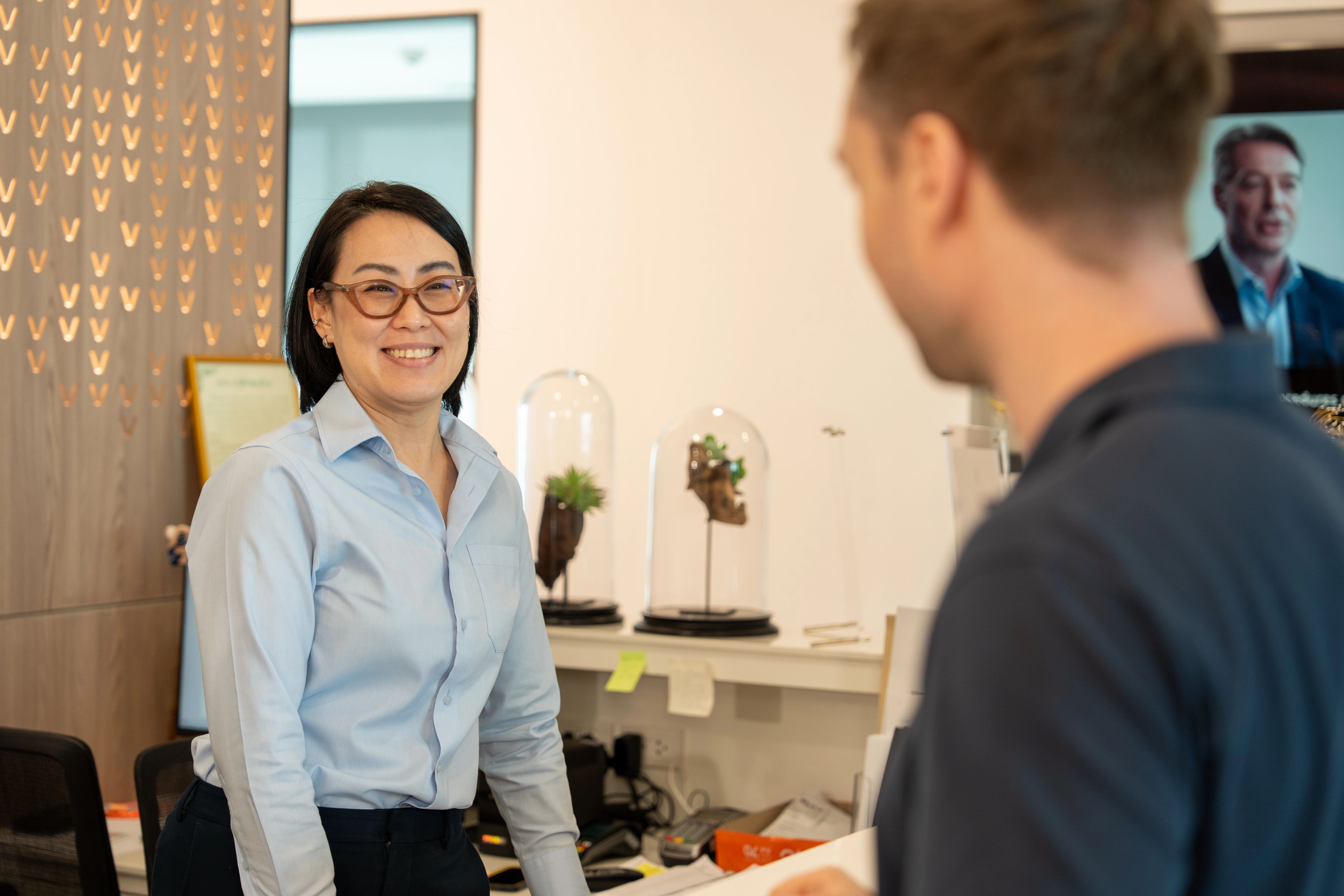Coordinator welcoming a patient at reception