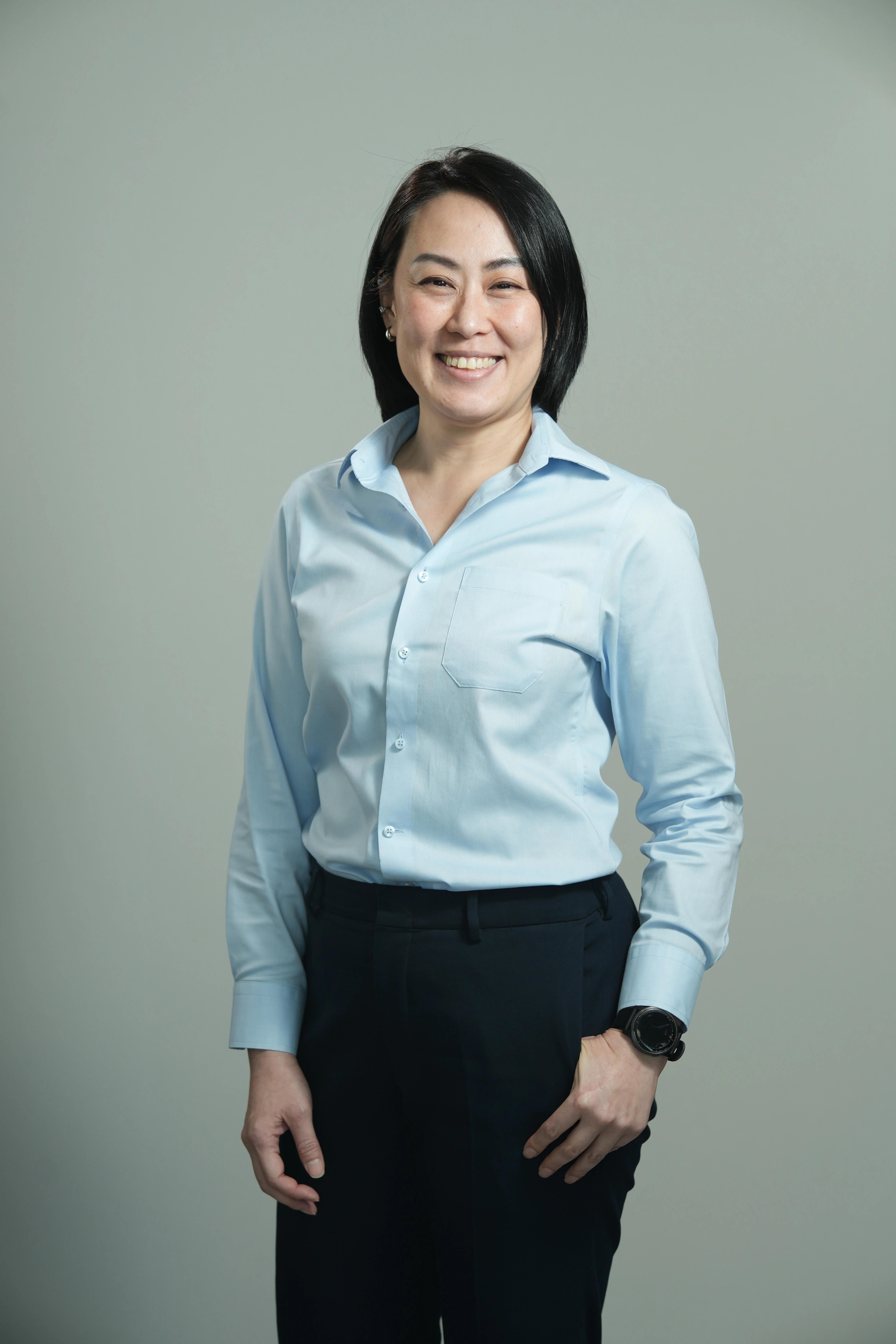 A smiling woman in a blue shirt