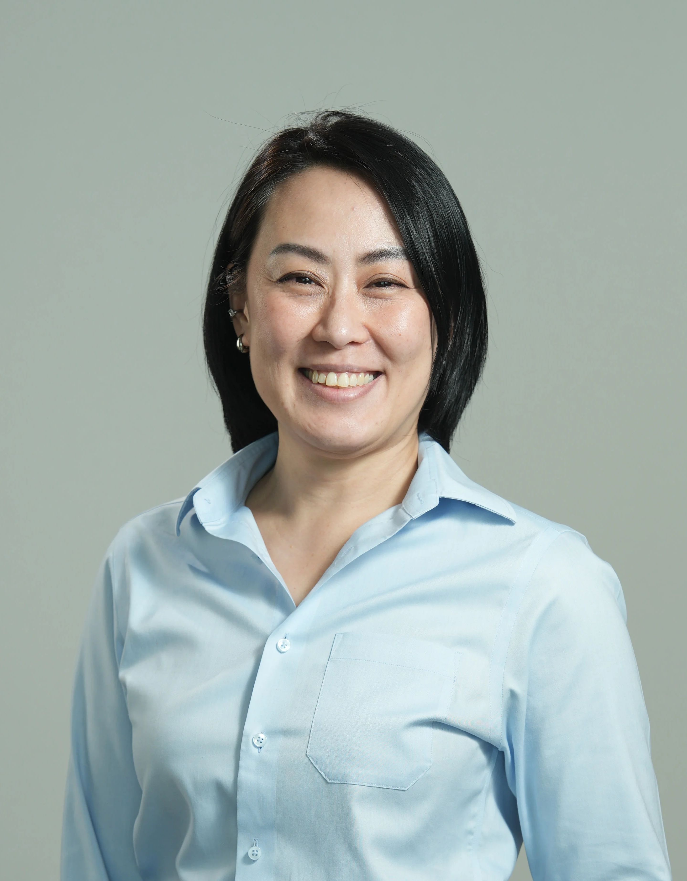 A smiling woman in a blue shirt