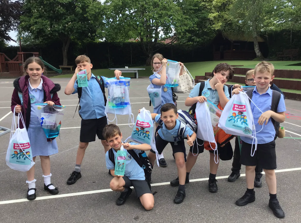 Students pose with their AquaSmart activities after a session