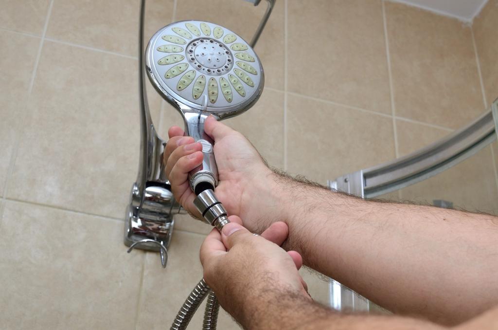 A person holds a showerhead