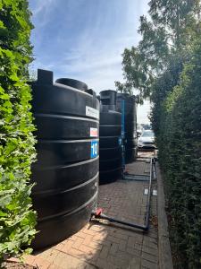Two large water tanks on the ground