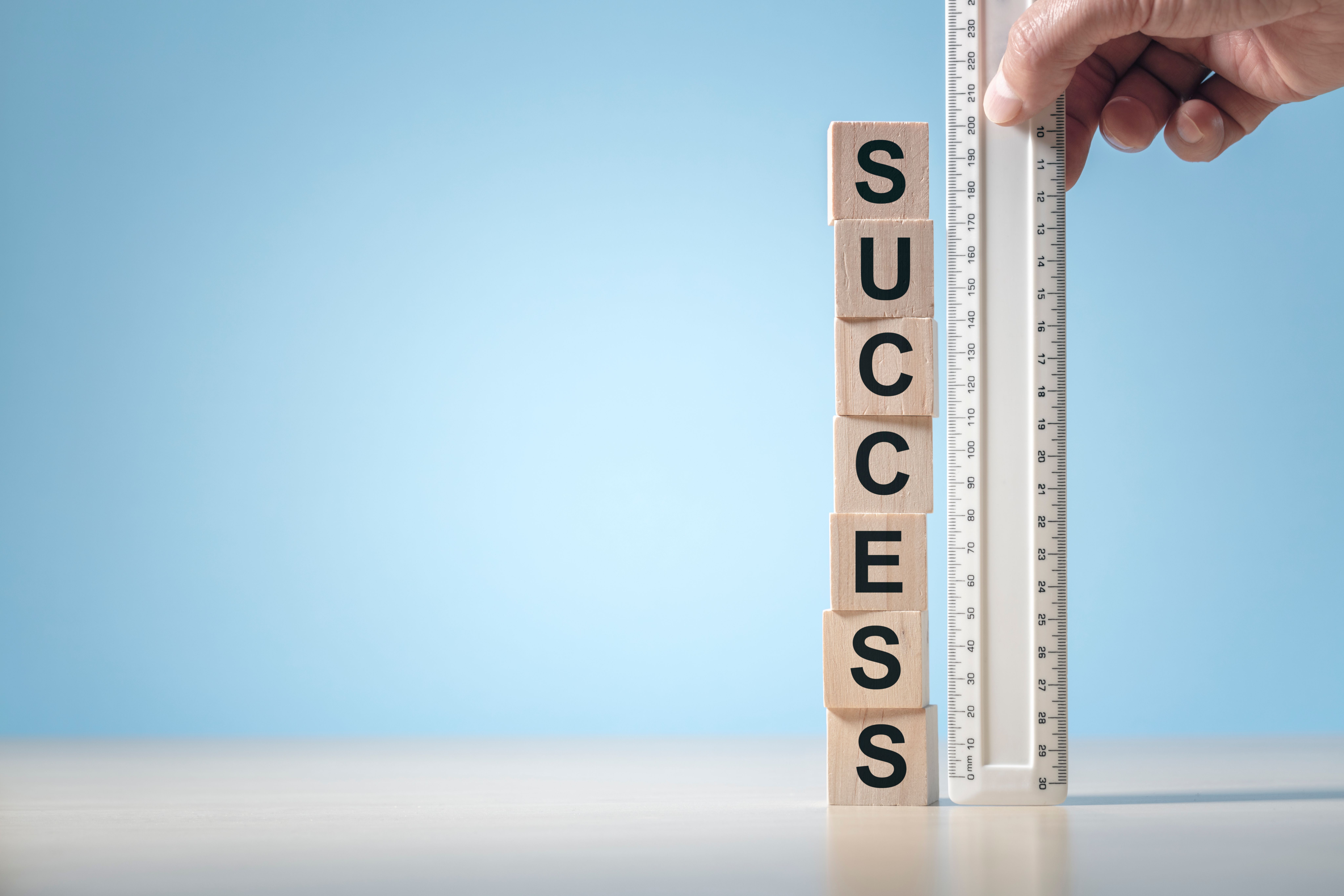 An upright ruler with the word SUCCESS written on it