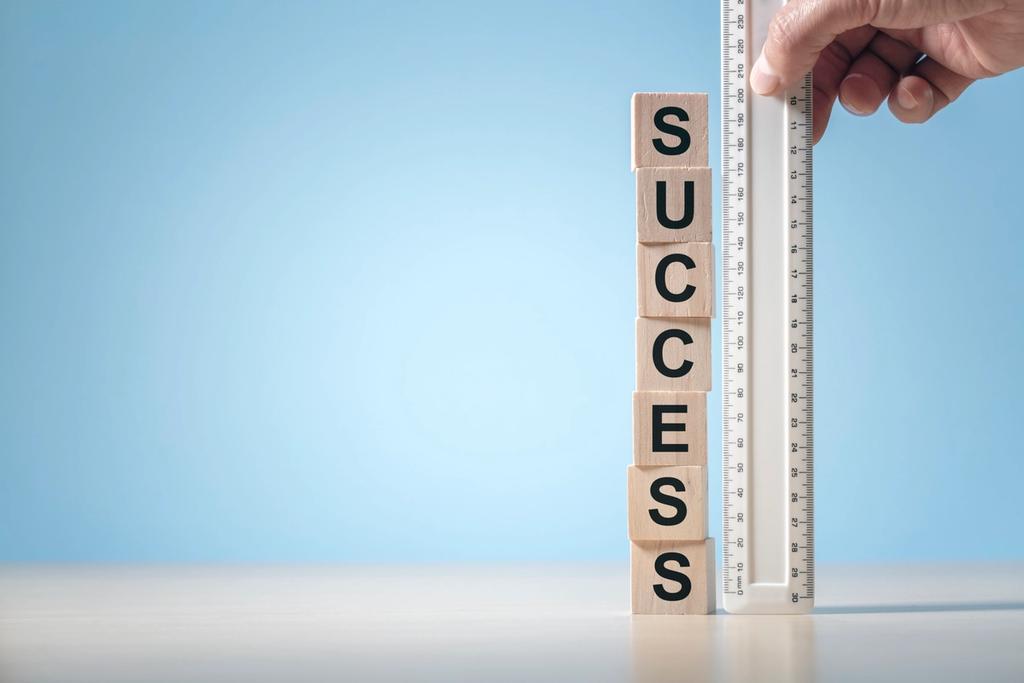 An upright ruler with the word SUCCESS written on it