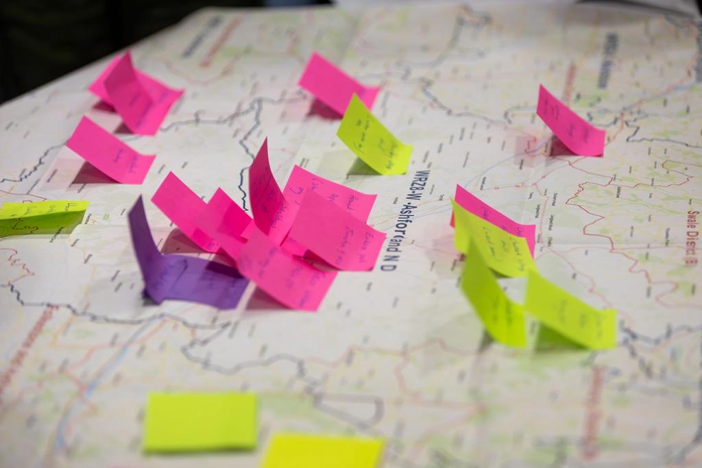 Pink, purple and yellow sticky notes on a map