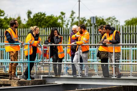 A group of people at the water treatment works talking