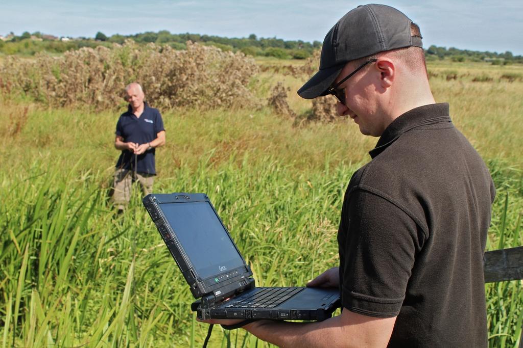 Man with laptop in field