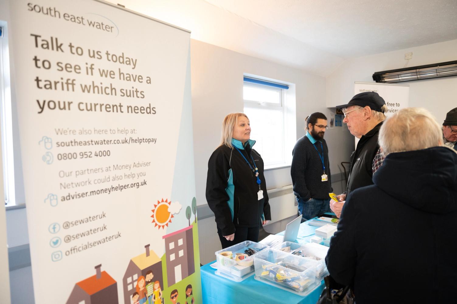 Photograph of members of the public chatting with a South East Water employee at a workshop