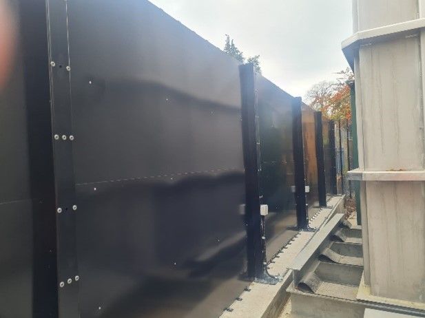 Panels in place behind black rigid mesh fencing