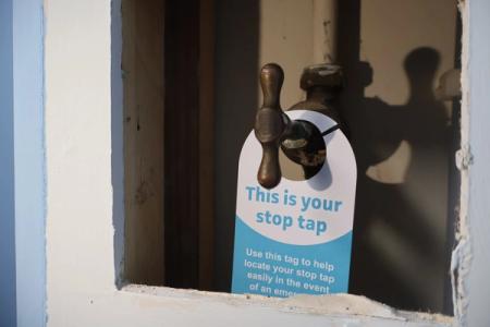 An internal stop tap with our South East Water tag which says 'This is your stop tag' around it.