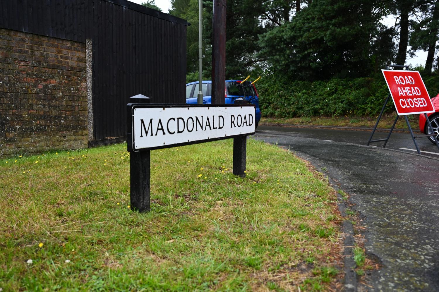 A road closed sign is pictured by the sign for MacDonald Road