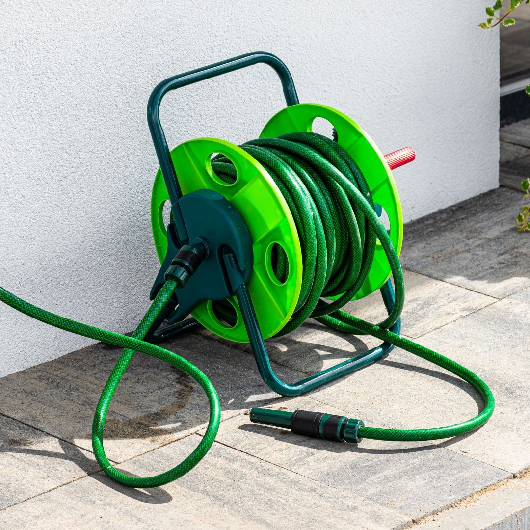 A green hosepipe that is reeled in. 