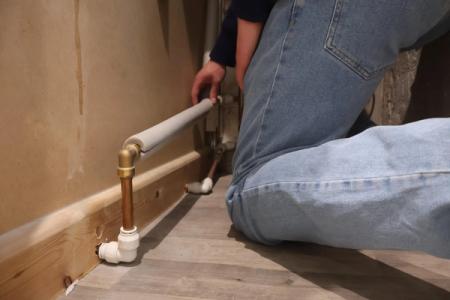 An internal pipe with grey pipe lagging wrapped around it.