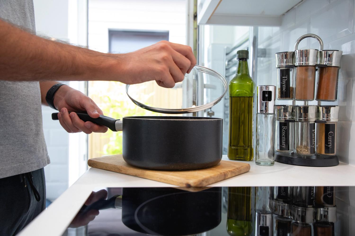 A person boiling water in a saucepan