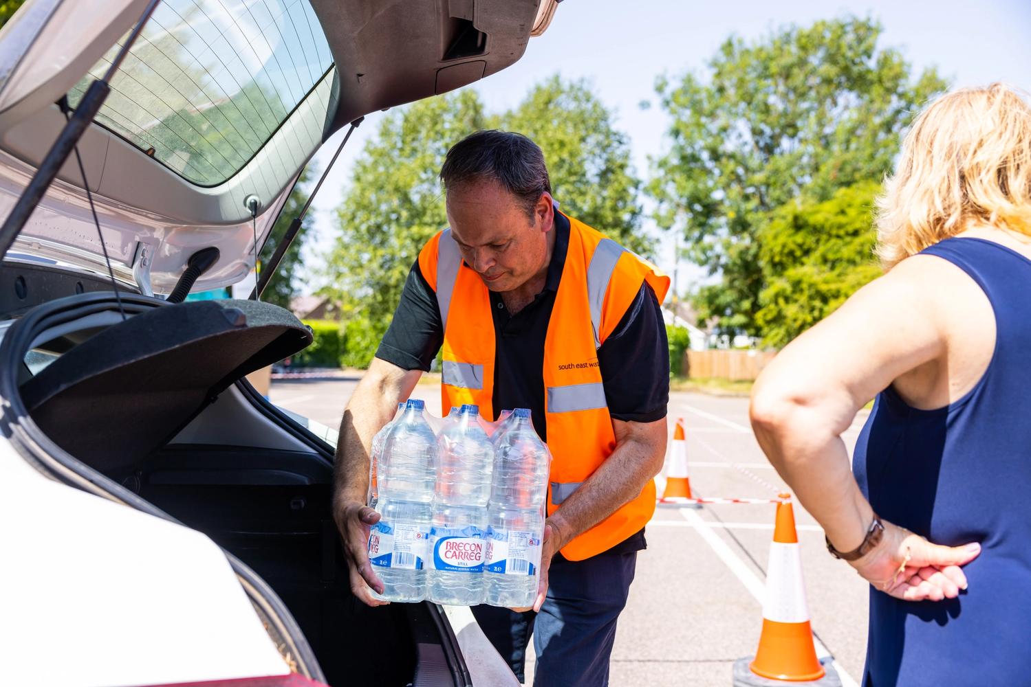 South East Water colleague handing out bottles of water to customers