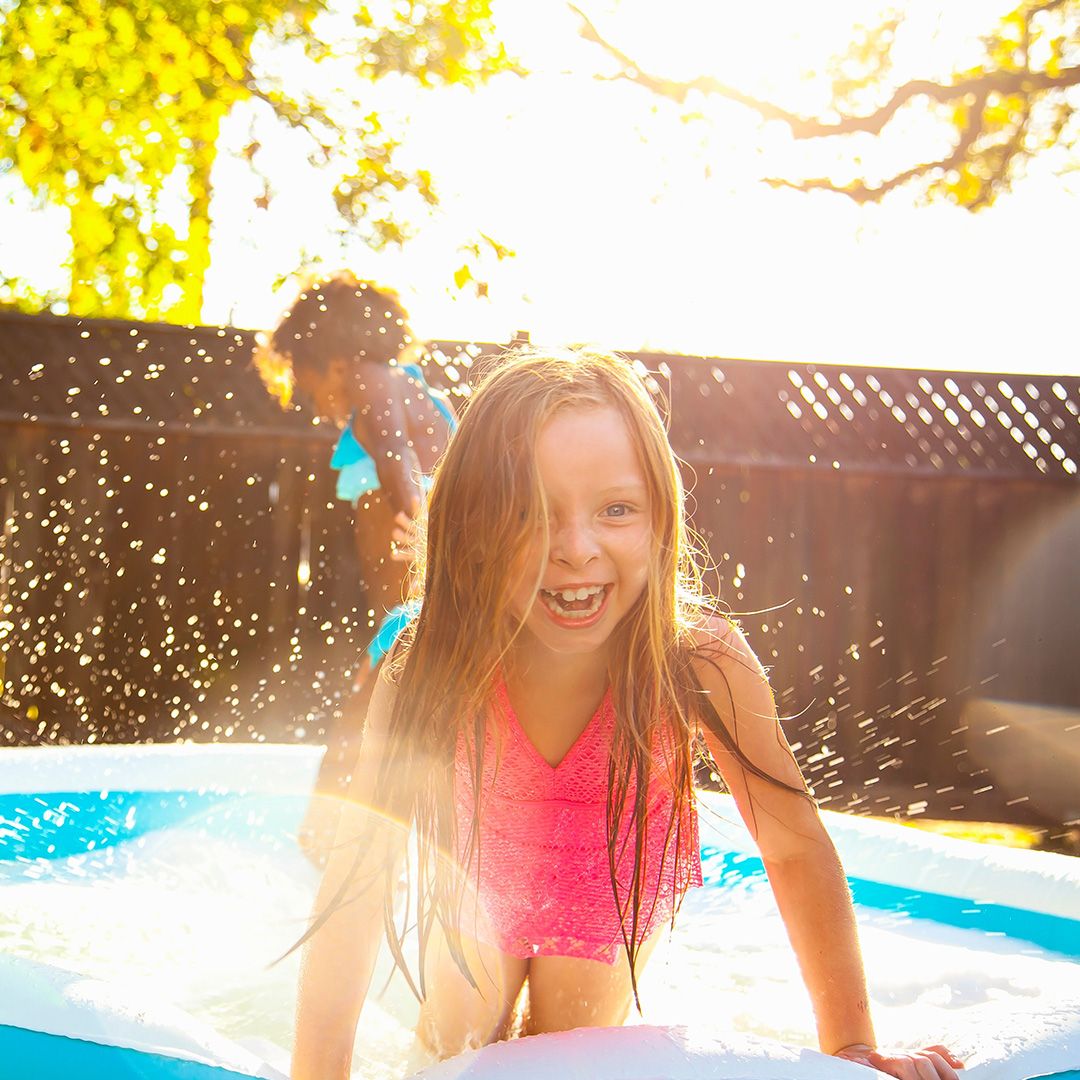 Photo of a child playing in a paddling pool 