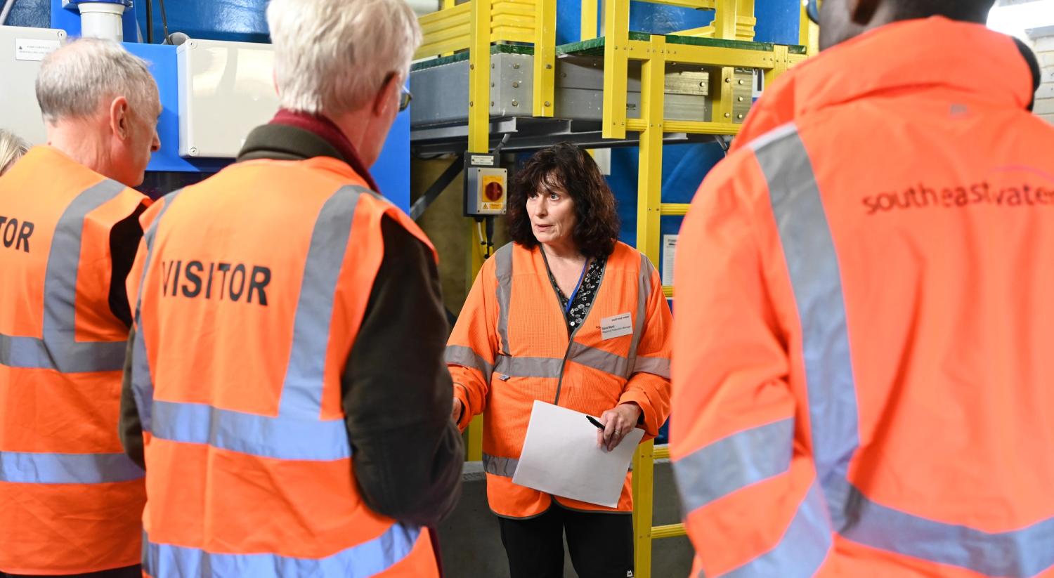 Visitors listen to a talk on site at College Avenue Water Treatment Works