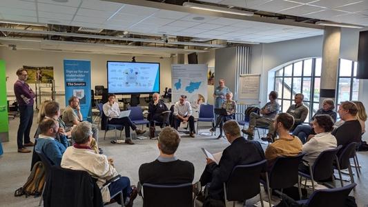 Photo of South East Water employees and stakeholders discussing a presentation at a conference