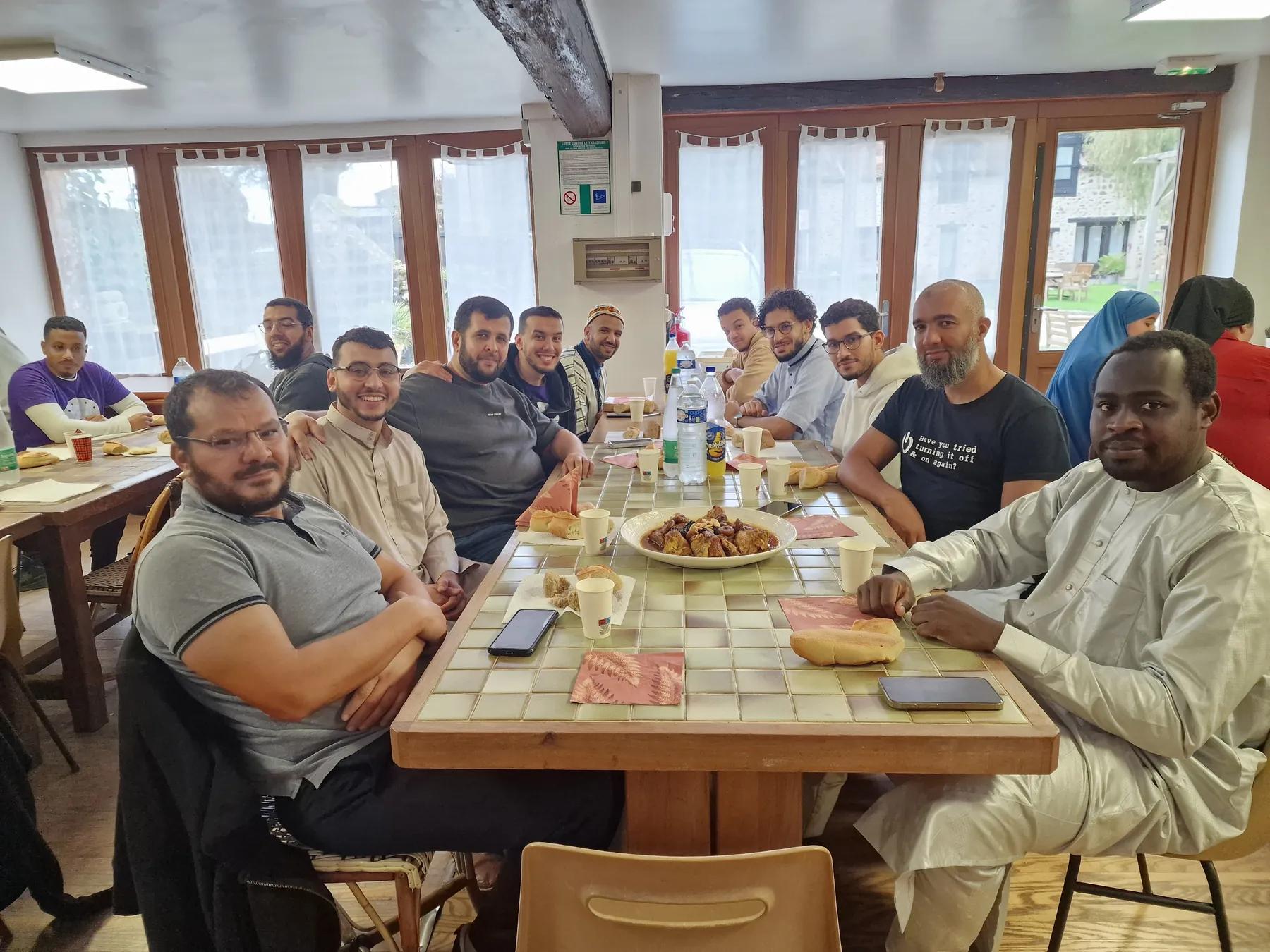 Volunteers sharing a meal around a table