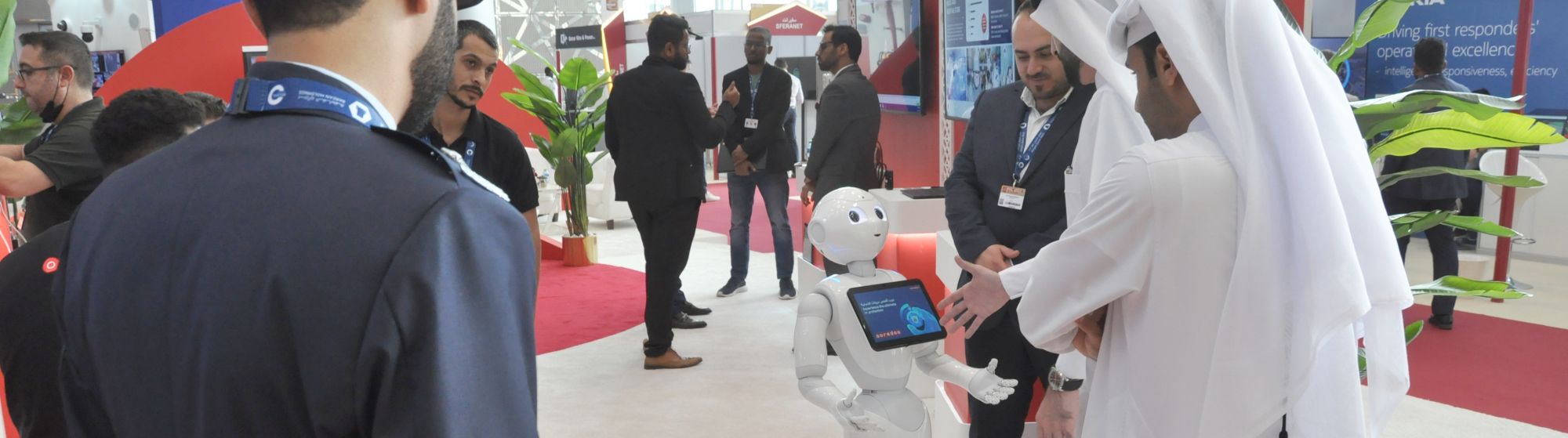 Business professionals networking at a trade show in Qatar and exploring new partnership opportunities