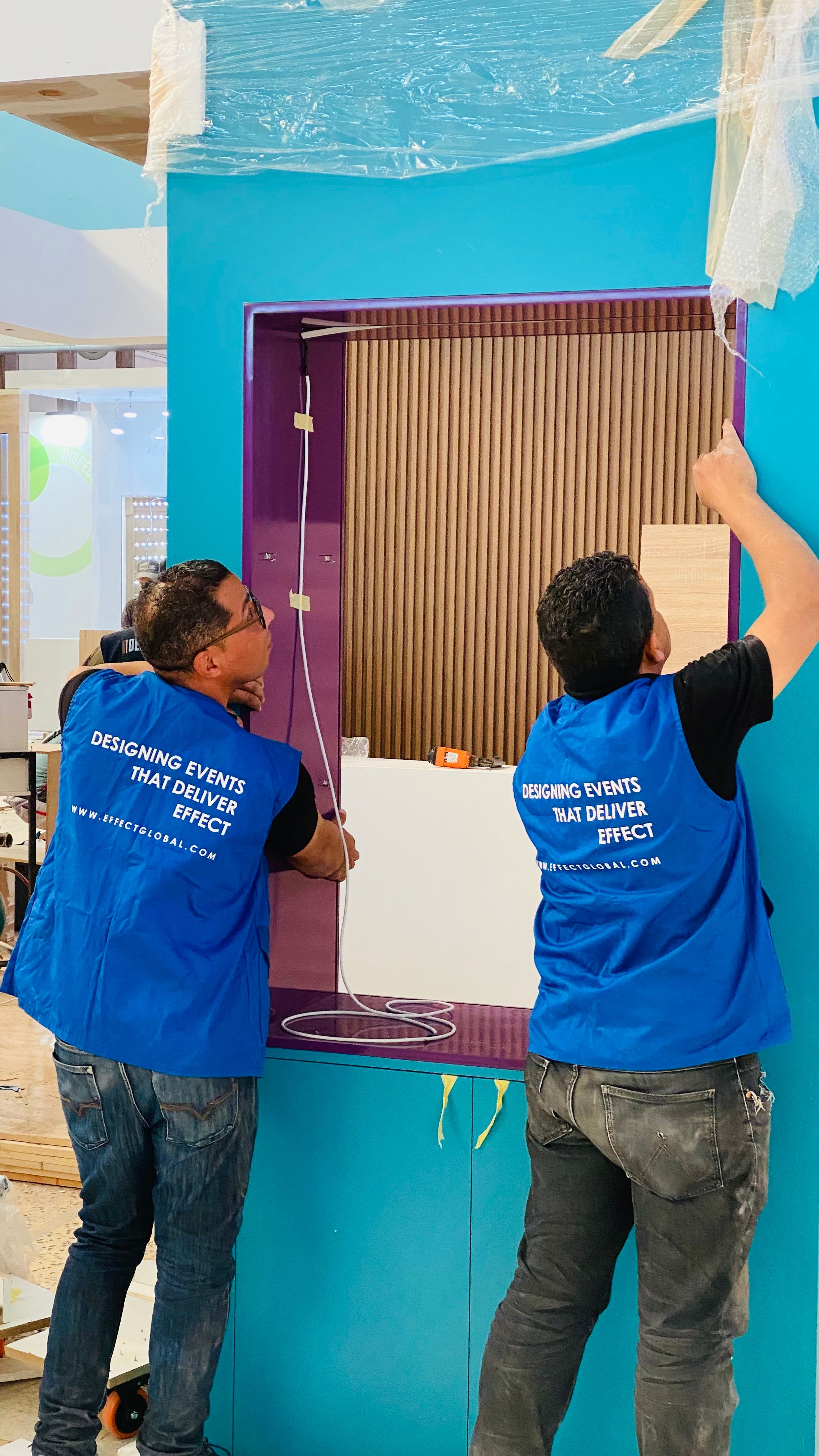 Professional team installing a custom exhibition stand before a trade show opening.