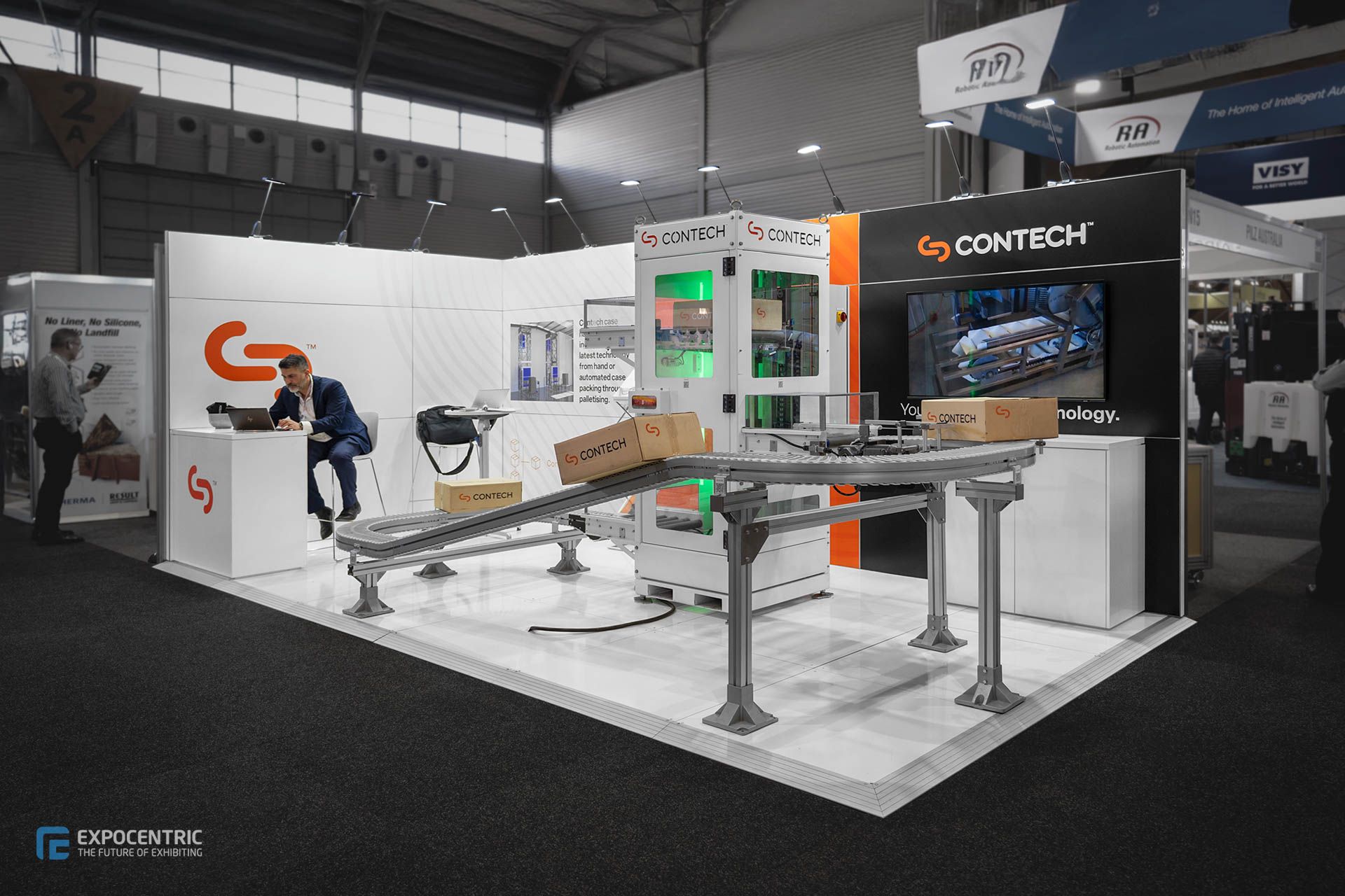 Exhibition stand with live industrial technology demonstration at trade show