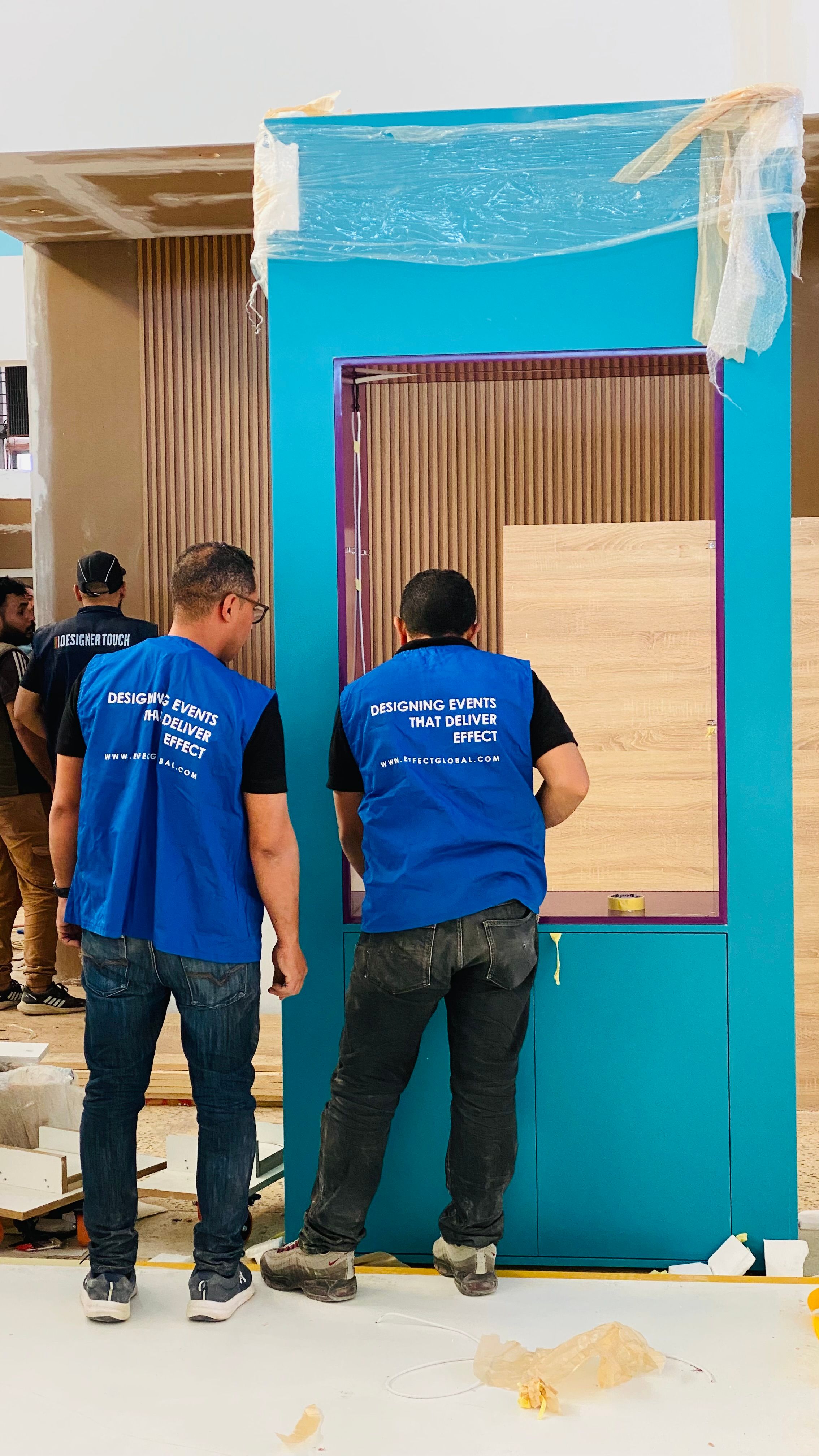 Exhibition stand construction and event logistics coordination during trade show setup in Qatar