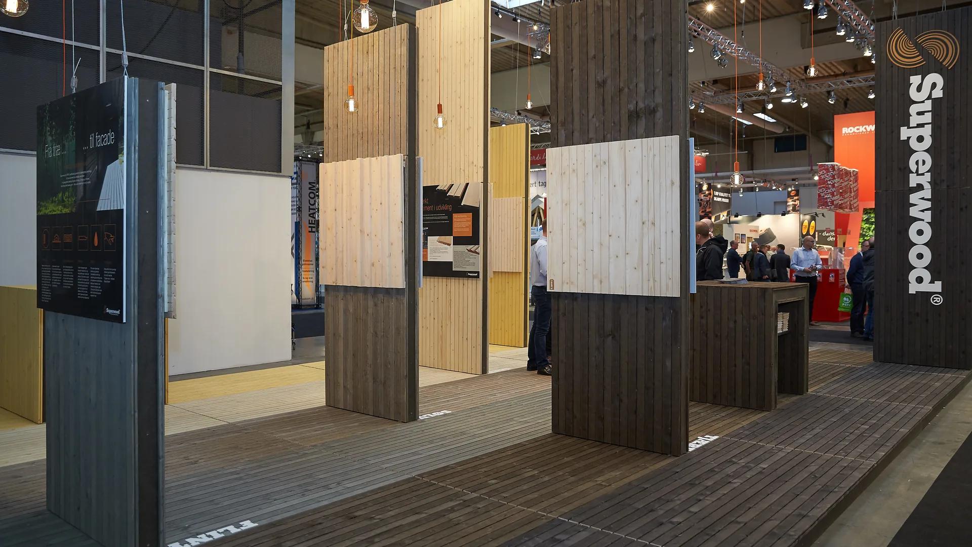 Exhibition stand with construction material product samples and display zones