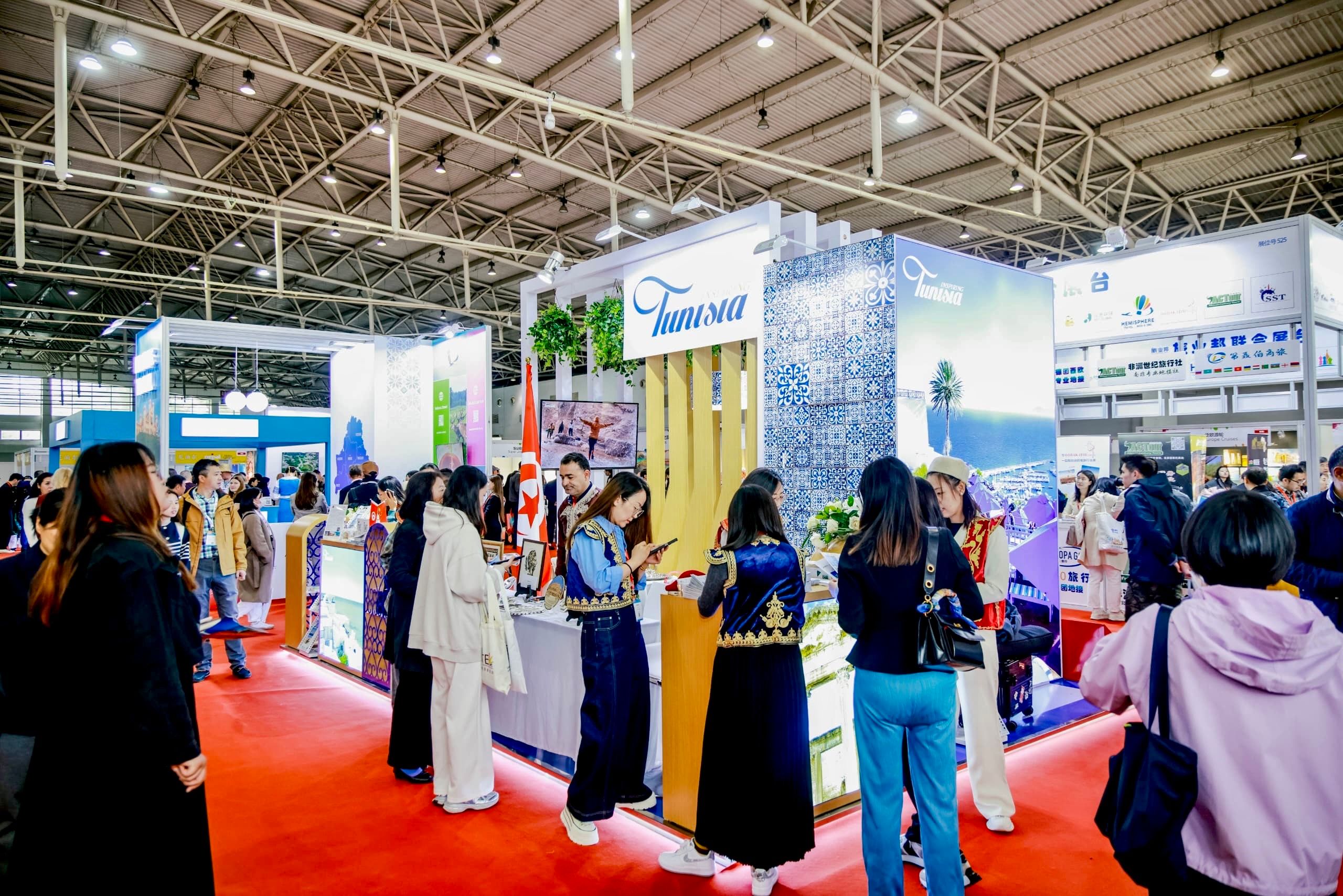 Visitors engaging with a company stand during a professional trade exhibition.