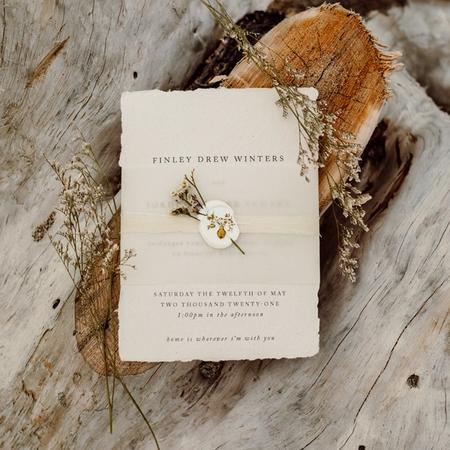 A custom designed wedding invitation with envelope and wax seal.