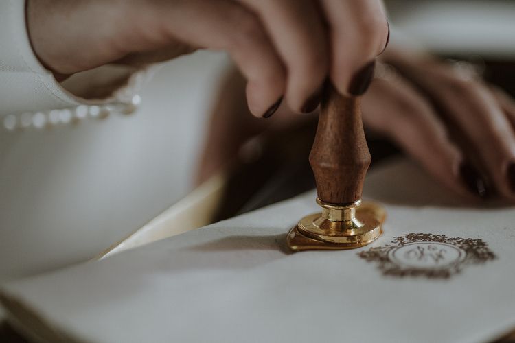 wax seal stamping into wax