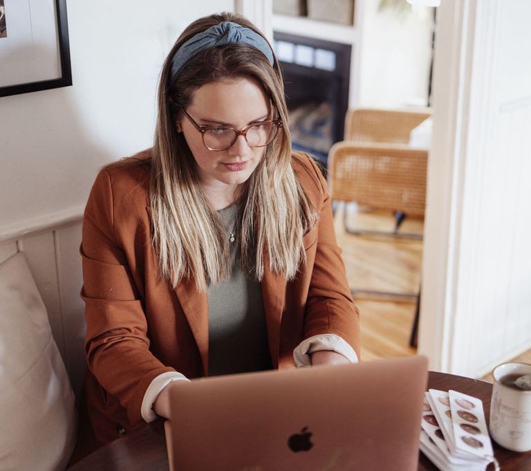 solopreneur business owner sitting in front of laptop