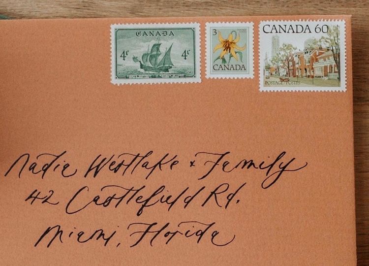 Vintage Postage Stamps on handwritten terra cotta envelope