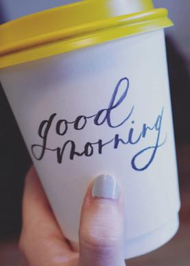 Coffee cup with "good morning" written in calligraphy