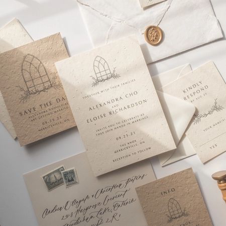 A custom designed wedding invitation with envelope and wax seal.