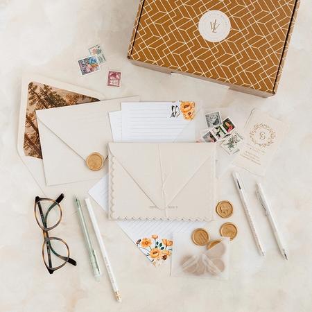Calligraphy tools on a table with Envelopes and wax seals.