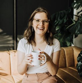 Cody posing and smiling with coffee