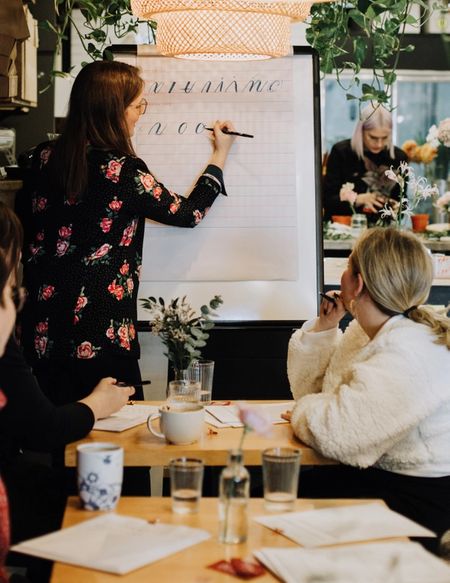 Calligraphy instructor does a live calligraphy demonstration for her students.