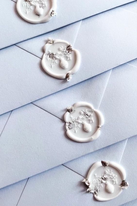 white wax seals with baby's breath wildflowers