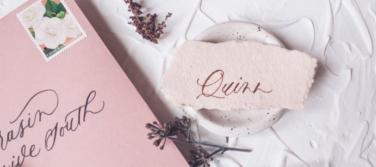 Place card with gender neutral name handwritten on handmade paper