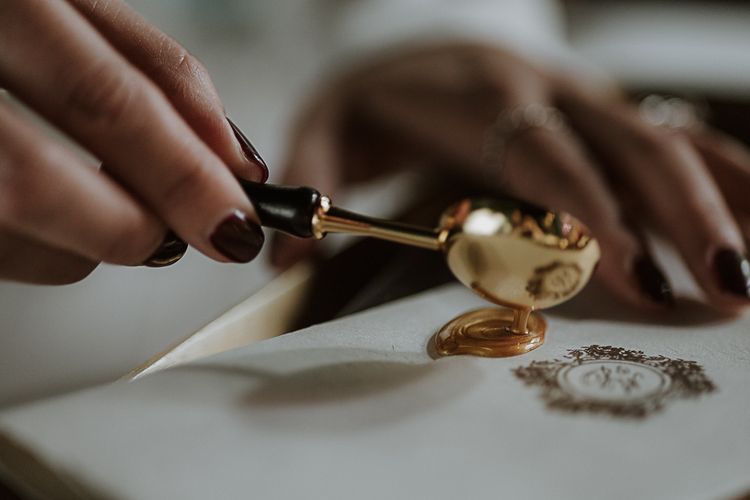 sealing wax spoon pouring wax onto paper