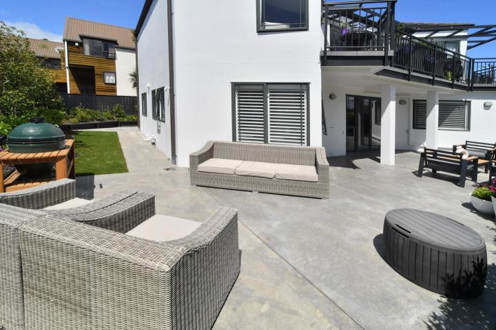 Concrete patio adjoining a contemporary home