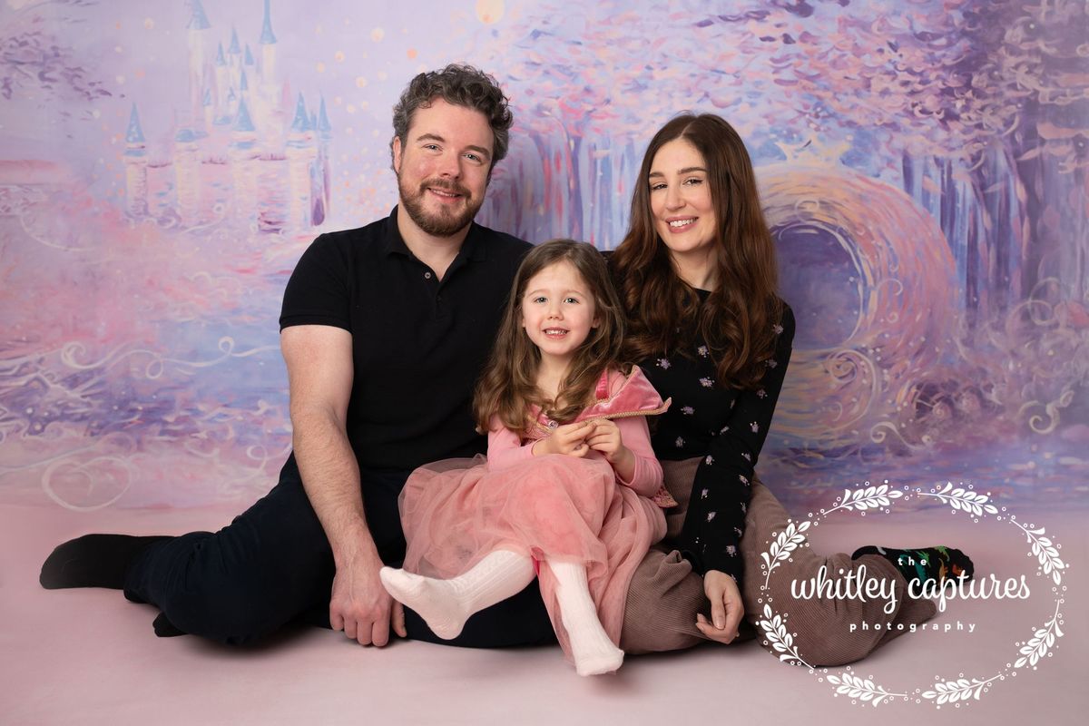 Parents sitting together with their young daughter